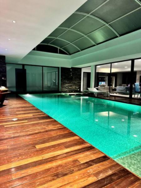 Luxury villa with a heated indoor pool and direct access to the beach
